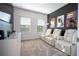 Home theater room features plush seating, dark accent wall and a large screen TV at 9513 Amber Chestnut Way, Winter Garden, FL 34787