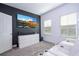 View of the theater room featuring white reclining chairs, dark accent wall and large screen television at 9513 Amber Chestnut Way, Winter Garden, FL 34787