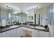 Bathroom featuring a double vanity, dual mirrors with lights, and a glass enclosed shower at 1019 Tuscan Hills Blvd, Davenport, FL 33897