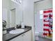 Bathroom featuring a sink with white cabinets and a mirror over looking the toilet and tub at 1019 Tuscan Hills Blvd, Davenport, FL 33897