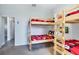 Bedroom featuring bunk beds with a wall mounted television and a door into an adjacent room at 1019 Tuscan Hills Blvd, Davenport, FL 33897