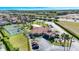 Aerial shot of a community clubhouse featuring a tennis court, and lush greenery in a well-maintained setting at 1019 Tuscan Hills Blvd, Davenport, FL 33897