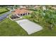 Aerial view featuring a volleyball court, playground, and community center, enhanced by palm trees and green spaces at 1019 Tuscan Hills Blvd, Davenport, FL 33897