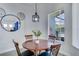 Cozy dining area with a dark wood table with seating for four and natural light at 1019 Tuscan Hills Blvd, Davenport, FL 33897