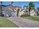 Beautiful home features lush green grass, long brick driveway and terracotta roof at 1019 Tuscan Hills Blvd, Davenport, FL 33897