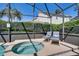 Relax in this inviting screened-in hot tub area, offering a tranquil space for relaxation and leisure at 1019 Tuscan Hills Blvd, Davenport, FL 33897