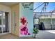 Outdoor patio area with decorative floral mural, grill, and view of the pool screen enclosure at 1019 Tuscan Hills Blvd, Davenport, FL 33897