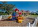 A colorful playground with slides and climbing structures is set against the backdrop of the community center at 1019 Tuscan Hills Blvd, Davenport, FL 33897