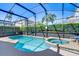 Inviting screened-in pool and spa with a serene backyard view provide a relaxing outdoor oasis at 1019 Tuscan Hills Blvd, Davenport, FL 33897