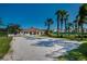 Scenic view of a sand volleyball court surrounded by lush greenery and palm trees on a bright, sunny day at 1019 Tuscan Hills Blvd, Davenport, FL 33897