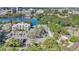 An elevated view capturing the building, parking area, a pool, and surrounding greenery near the lakeside at 1100 Delaney Ave # E13, Orlando, FL 32806