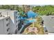 Aerial view showcases the community's pool, garden, lake, and scenic surroundings at 1100 Delaney Ave # E13, Orlando, FL 32806