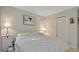 Bright bedroom features plush bedding, side tables and double-door closet at 1100 Delaney Ave # E13, Orlando, FL 32806