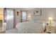 Cozy bedroom features all-white decor, plush bedding and picture windows at 1100 Delaney Ave # E13, Orlando, FL 32806