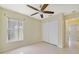 Bedroom featuring a window, closet, and ceiling fan at 1110 Stoneham Dr, Groveland, FL 34736