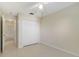 Bright bedroom featuring neutral walls, tiled flooring, ceiling fan, and closet with white doors at 1110 Stoneham Dr, Groveland, FL 34736