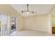 Light-filled living room with sliding glass doors leading to an outdoor patio area at 1110 Stoneham Dr, Groveland, FL 34736