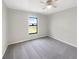 Neutral bedroom featuring carpet flooring, ceiling fan, and window with a view at 1172 Moyle Way, Mascotte, FL 34753