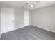 Neutral bedroom featuring carpet flooring and two large closets at 1172 Moyle Way, Mascotte, FL 34753