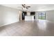 Open-concept living space with tiled floors and natural light, great for entertaining at 1172 Moyle Way, Mascotte, FL 34753