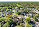 This aerial showcases a tranquil neighborhood setting with tree-lined streets and lush greenery and beautiful homes at 134 Woodleaf Dr, Winter Springs, FL 32708