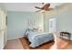 Bedroom showcasing a comfortable bed, ceiling fan, and view of the en-suite bathroom at 134 Woodleaf Dr, Winter Springs, FL 32708