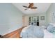 Relaxing bedroom with beautiful hardwood floors, a ceiling fan, and a calming color palette at 134 Woodleaf Dr, Winter Springs, FL 32708