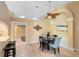 Dining room with tile flooring, modern light fixture, and convenient bar seating area at 134 Woodleaf Dr, Winter Springs, FL 32708