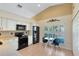 Eat-in kitchen with white cabinetry, stainless steel appliances and a vaulted ceiling at 134 Woodleaf Dr, Winter Springs, FL 32708