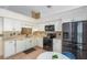 Modern kitchen featuring white cabinets, stainless steel appliances, and tiled flooring at 134 Woodleaf Dr, Winter Springs, FL 32708