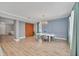 Bright dining room with wood floors, stylish lighting, and comfortable seating at 14815 Tullamore Loop, Winter Garden, FL 34787