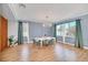 Bright dining room featuring hardwood floors, modern chandelier, and large windows at 14815 Tullamore Loop, Winter Garden, FL 34787