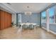 Dining room has hardwood floors, modern lighting, blue accent walls, and large windows at 14815 Tullamore Loop, Winter Garden, FL 34787