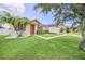 Attractive single-story home features a well-manicured lawn, palm trees, and covered entryway at 14815 Tullamore Loop, Winter Garden, FL 34787