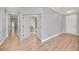 Hallway with hardwood floors leading to a bedroom and entrance to another living space at 14815 Tullamore Loop, Winter Garden, FL 34787