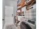 Well-equipped laundry room with modern washer and dryer, utility sink, and storage shelves at 14815 Tullamore Loop, Winter Garden, FL 34787