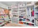 A spacious walk-in closet with custom shelving and storage solutions for organization at 14815 Tullamore Loop, Winter Garden, FL 34787