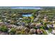 Aerial view of a lovely neighborhood, showcasing a home with a nearby lake and mature trees at 221 Calliope St, Ocoee, FL 34761