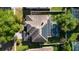 Aerial view of a home with solar panels, screened pool, and lush landscaping, showcasing energy efficiency at 221 Calliope St, Ocoee, FL 34761