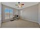 Simple bedroom with neutral carpet, colorful fan, and large window at 221 Calliope St, Ocoee, FL 34761