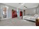 Bright bedroom featuring two red display cabinets, neutral paint, and carpet flooring at 221 Calliope St, Ocoee, FL 34761