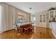 Bright dining room with laminate floors, a large window with natural light, and designer light fixture at 221 Calliope St, Ocoee, FL 34761