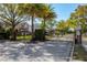 A grand gated community entrance with wrought iron gates, mature landscaping, and a neighborhood watch sign at 221 Calliope St, Ocoee, FL 34761