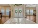 Elegant foyer boasting marble flooring, decorative glass doors, and views to the rest of the house at 221 Calliope St, Ocoee, FL 34761