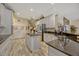 Stylish kitchen featuring grey tile floors, white cabinets, a center island, and granite countertops at 221 Calliope St, Ocoee, FL 34761