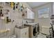 Functional laundry room with washer, dryer, sink, storage cabinets, and natural light from the window at 221 Calliope St, Ocoee, FL 34761