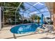 A private screened-in pool area with a uniquely shaped pool and a spacious deck for entertaining at 221 Calliope St, Ocoee, FL 34761