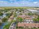 Sprawling aerial shot of a residential area with neatly arranged townhomes, mature trees, and a mix of commercial spaces at 2471 Tahoe Cir # 00, Winter Park, FL 32792