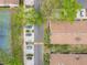 Overhead view of the townhome community featuring neatly arranged parking, mature trees, and a tennis court at 2471 Tahoe Cir # 00, Winter Park, FL 32792