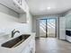 Kitchen featuring stainless steel sink and countertop, glass sliding door, and storage area at 2471 Tahoe Cir # 00, Winter Park, FL 32792